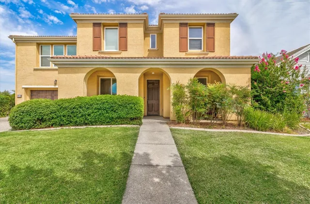 a front view of a house with garden