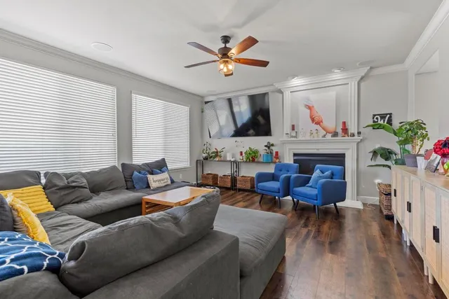 a living room with furniture a fireplace and a window
