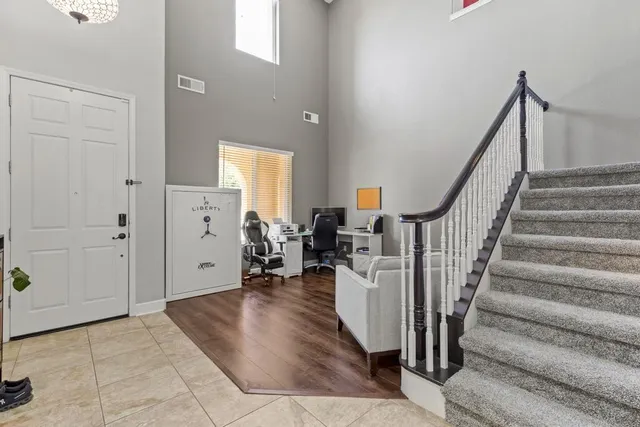 a view of entryway and hall with wooden floor