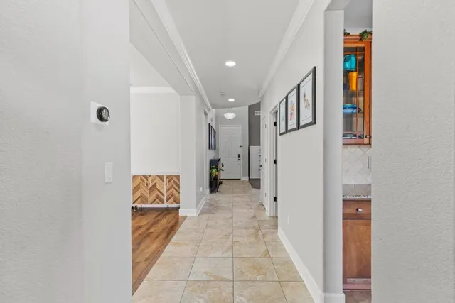 a view of a hallway with entryway and furniture