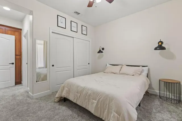 a bedroom with a bed and a chandelier