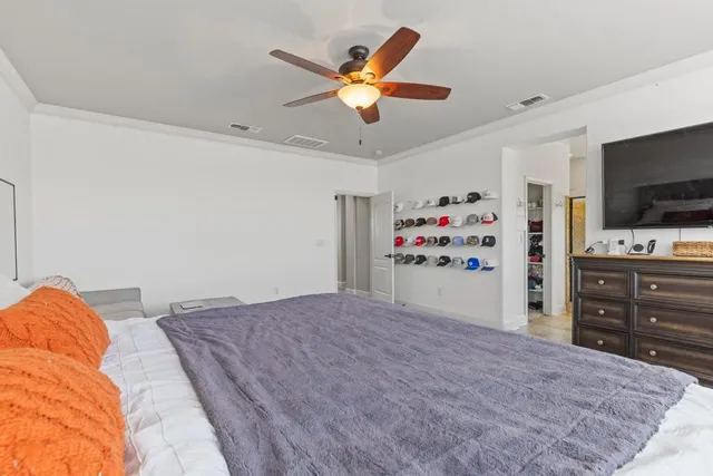 a bedroom with a bed and a flat screen tv