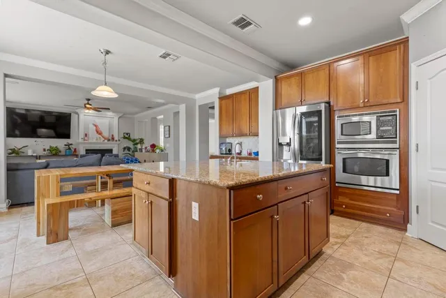 a kitchen with stainless steel appliances granite countertop a stove and cabinets