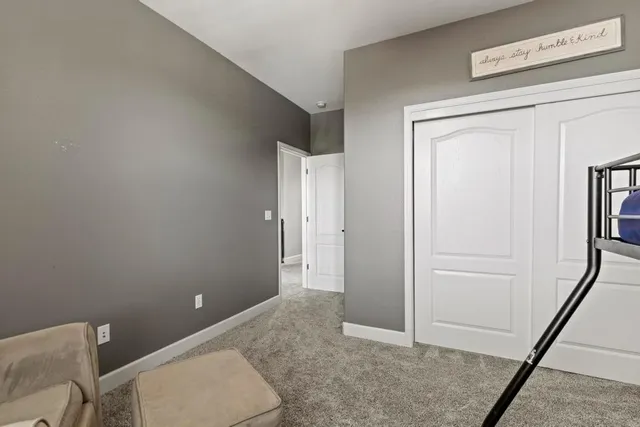 a living room with furniture gym equipment and a chandelier