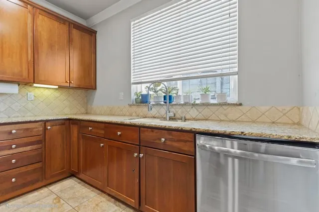 a kitchen with granite countertop cabinets and window