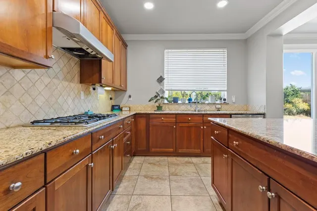 a kitchen with a sink stove and cabinets