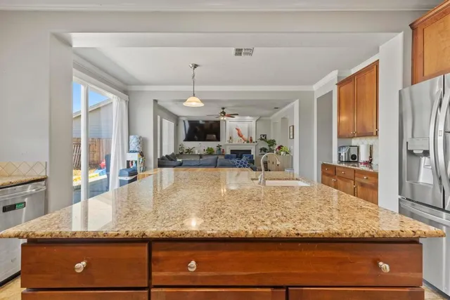a view of kitchen counter top kitchen island sink and refrigerator