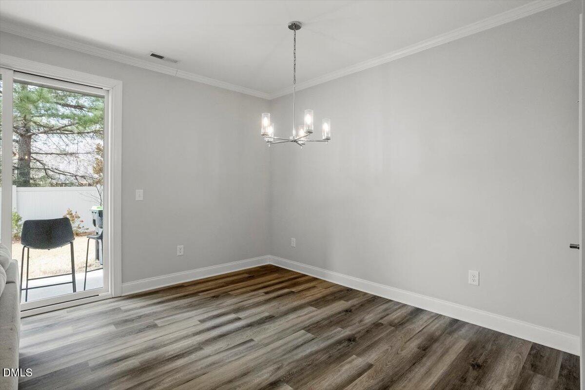 603 Marshskip Way Rolesville, NC 27571 - Photo 14 of 28 a view of a room with wooden floor and white walls