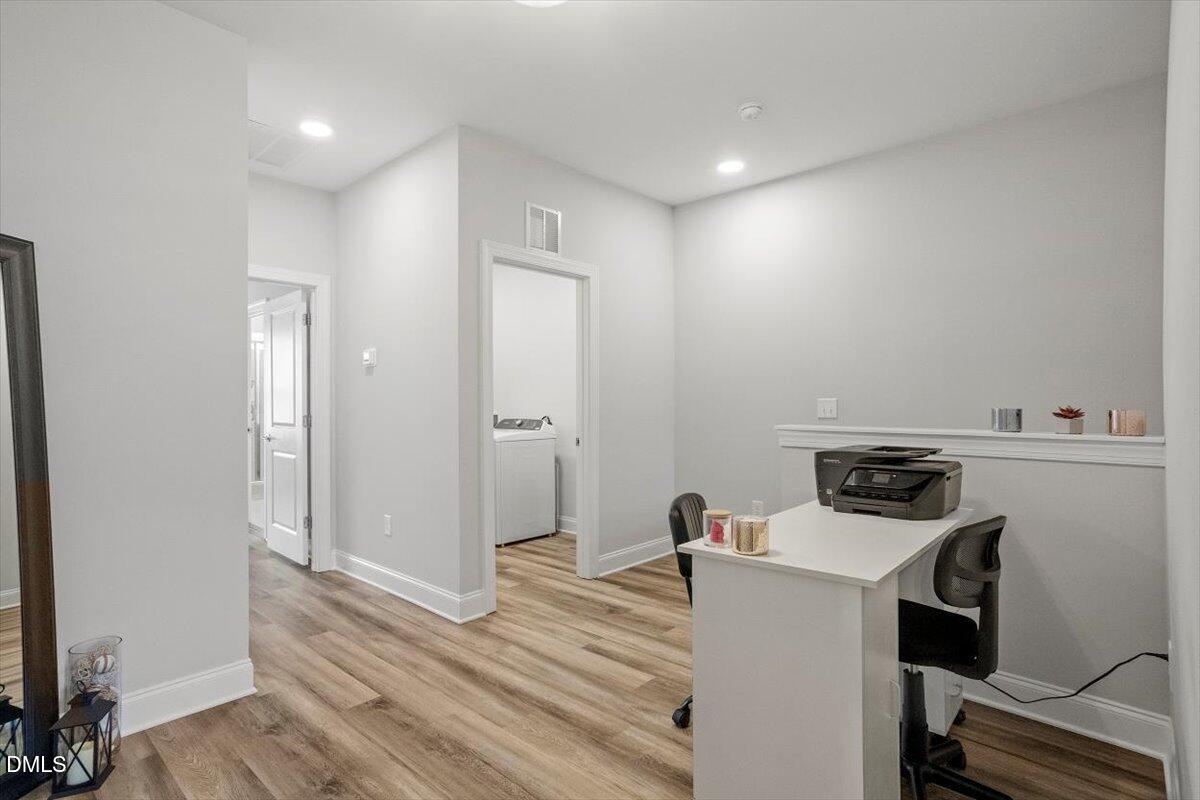 603 Marshskip Way Rolesville, NC 27571 - Photo 15 of 28 a view of a kitchen with refrigerator and wooden floor