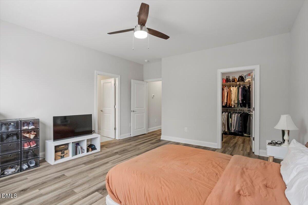 603 Marshskip Way Rolesville, NC 27571 - Photo 18 of 28 a bedroom with a bed and a flat screen tv