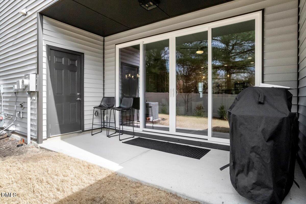 603 Marshskip Way Rolesville, NC 27571 - Photo 27 of 28 a building exterior with furniture and floor to ceiling window