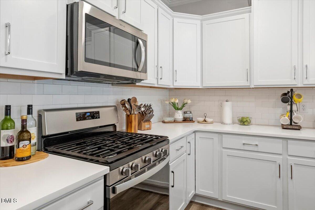 603 Marshskip Way Rolesville, NC 27571 - Photo 8 of 28 a kitchen with white cabinets and appliances