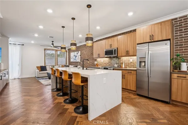 a kitchen with stainless steel appliances granite countertop a refrigerator a oven a sink and a island