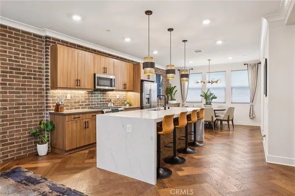 a kitchen with kitchen island granite countertop lots of counter top space and stainless steel appliances