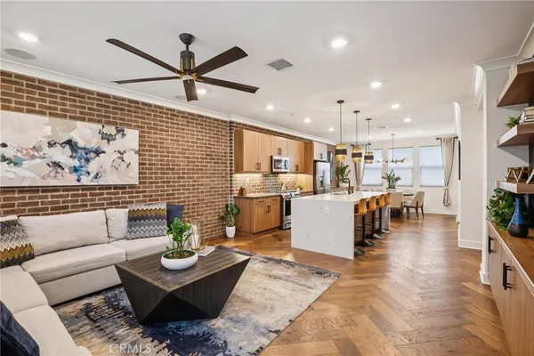 a living room with furniture and kitchen view