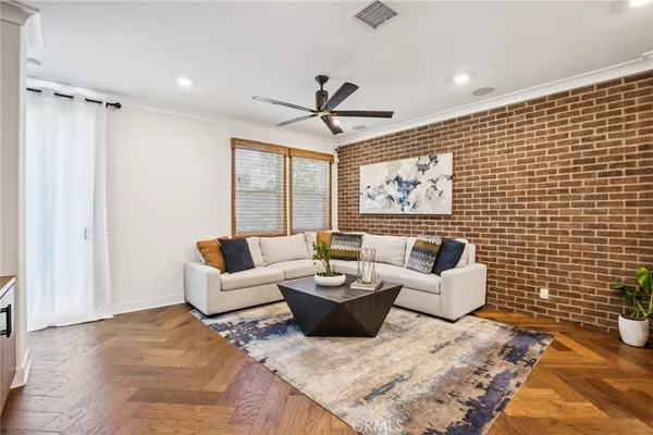 a living room with furniture a rug and a chandelier
