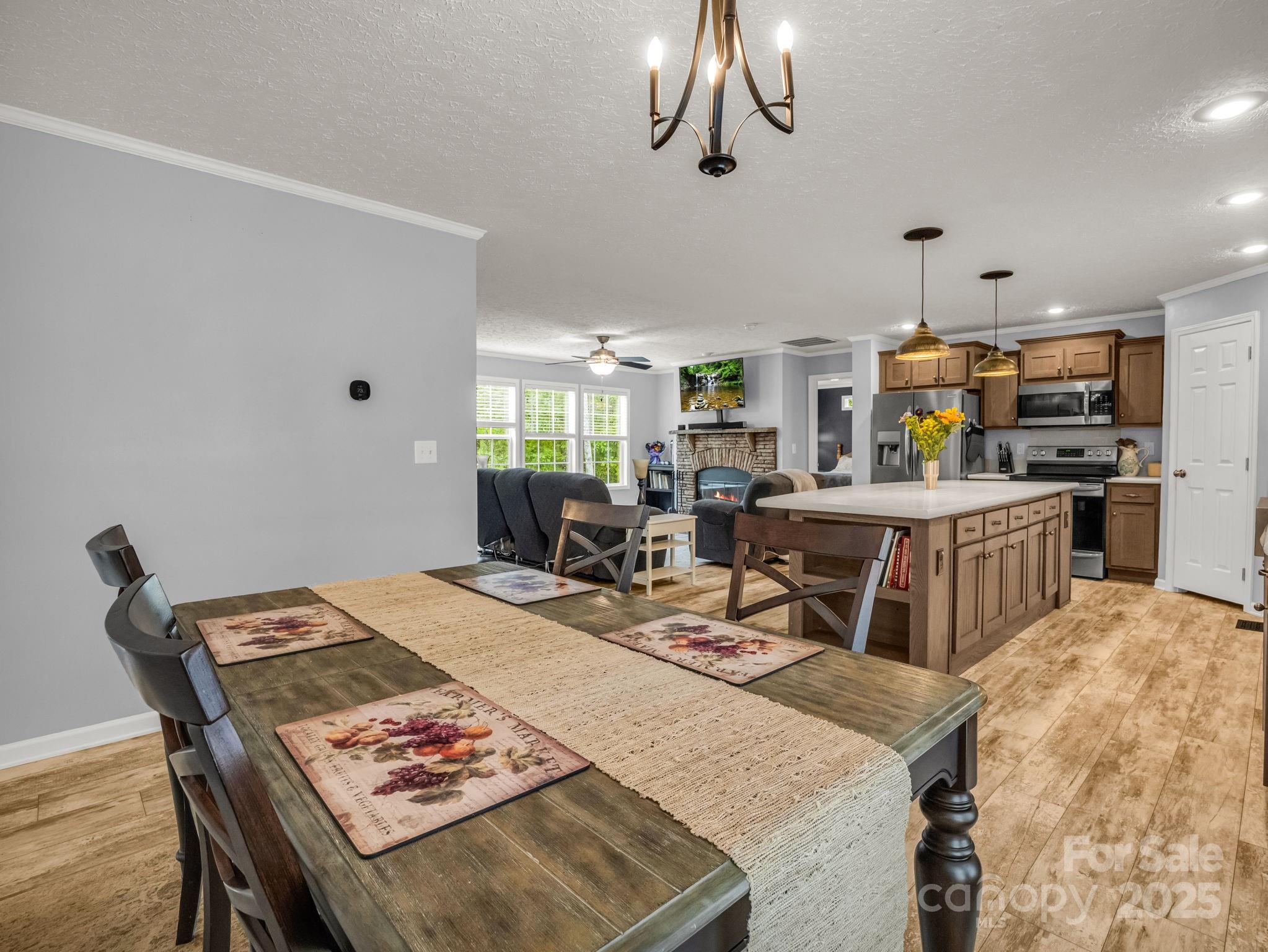 343 East Marshall Ridge Road Hendersonville, NC 28792 - Photo 11 of 44 a living room with stainless steel appliances furniture a rug kitchen view and a table