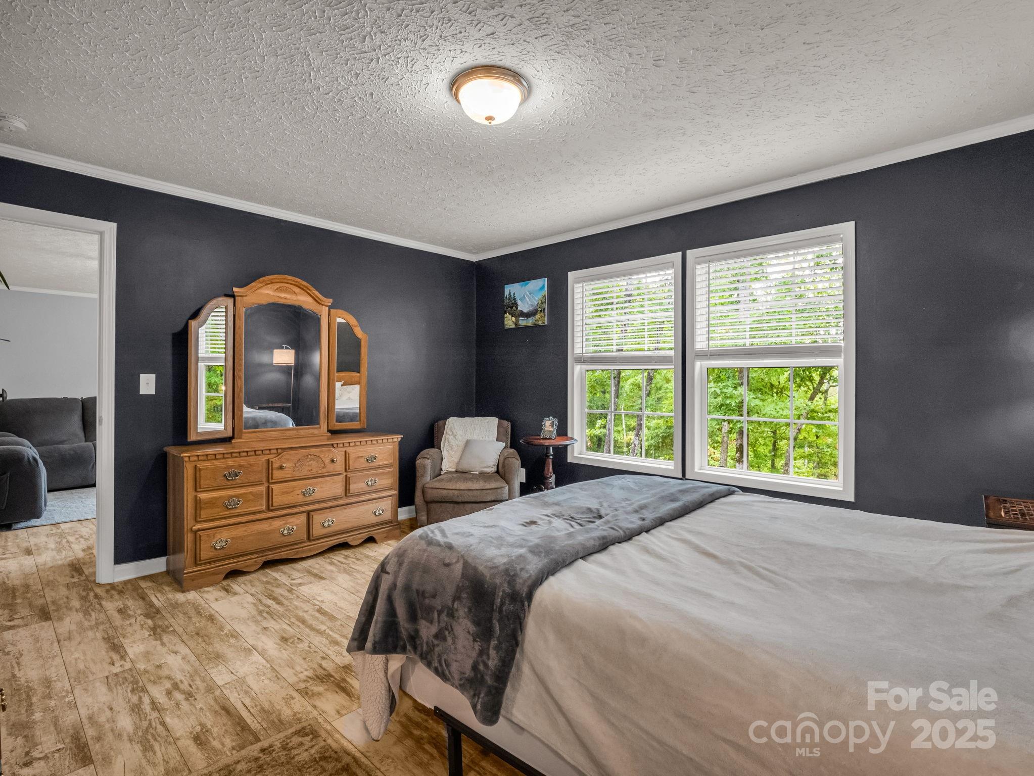 343 East Marshall Ridge Road Hendersonville, NC 28792 - Photo 14 of 44 a bedroom with a bed and a large window