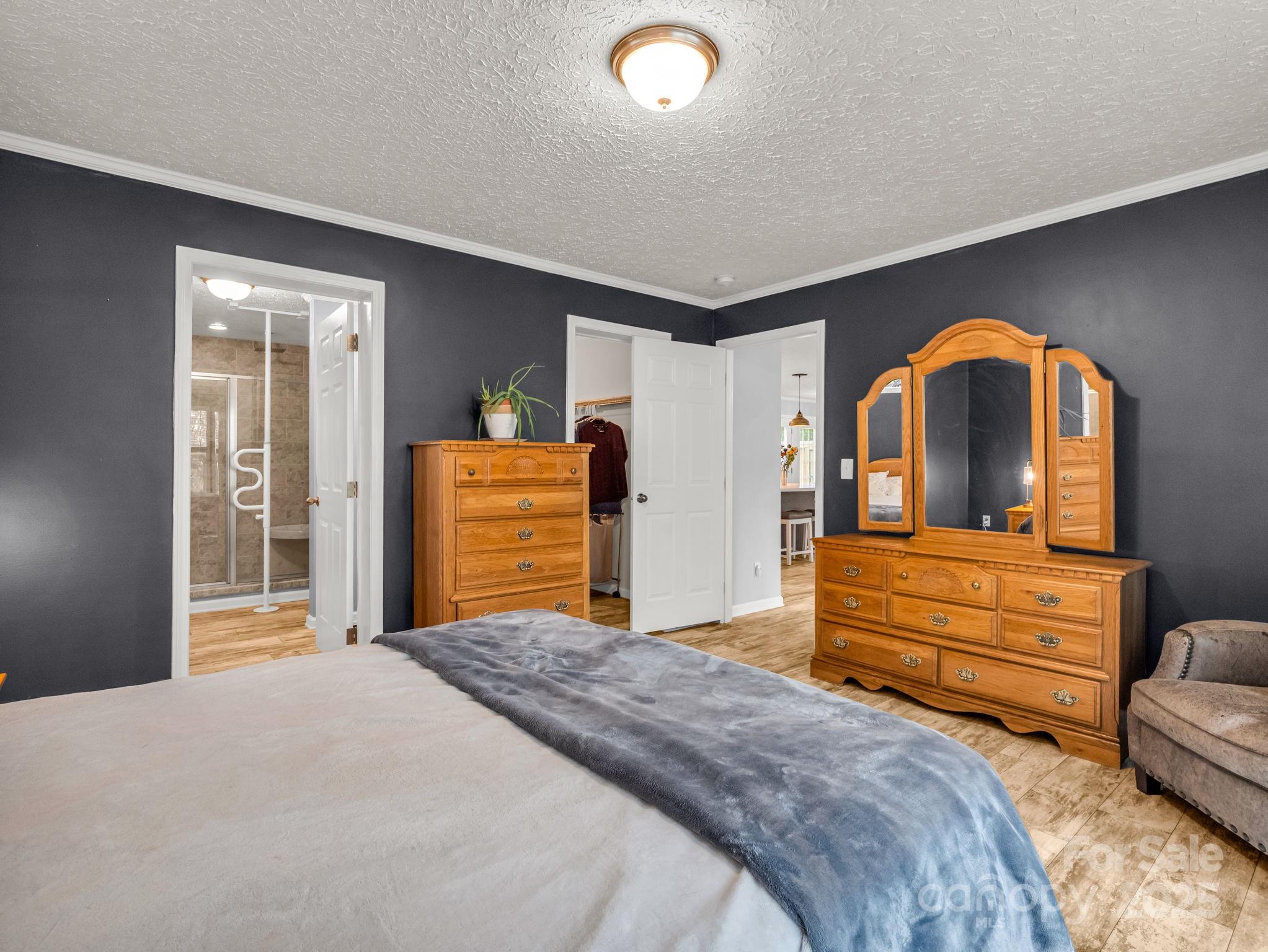 343 East Marshall Ridge Road Hendersonville, NC 28792 - Photo 15 of 44 a bedroom with a bed and a dresser