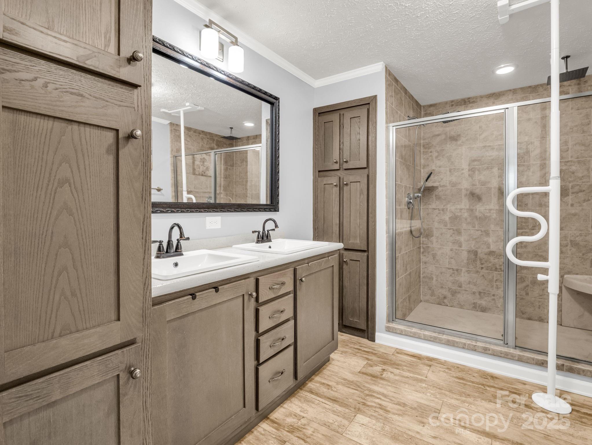 343 East Marshall Ridge Road Hendersonville, NC 28792 - Photo 16 of 44 a bathroom with a double vanity sink mirror and shower
