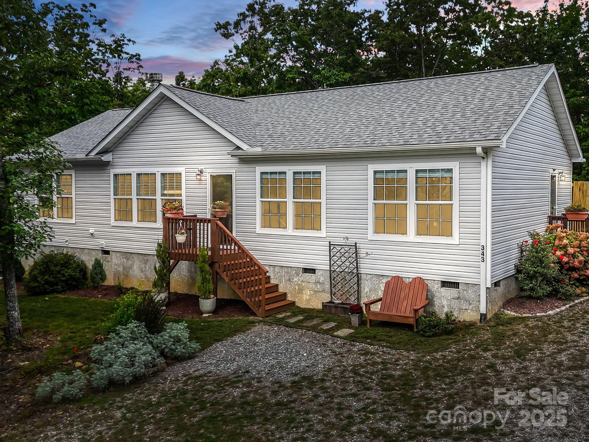 343 East Marshall Ridge Road Hendersonville, NC 28792 - Photo 2 of 44 a view of a house with a yard chairs and a garage