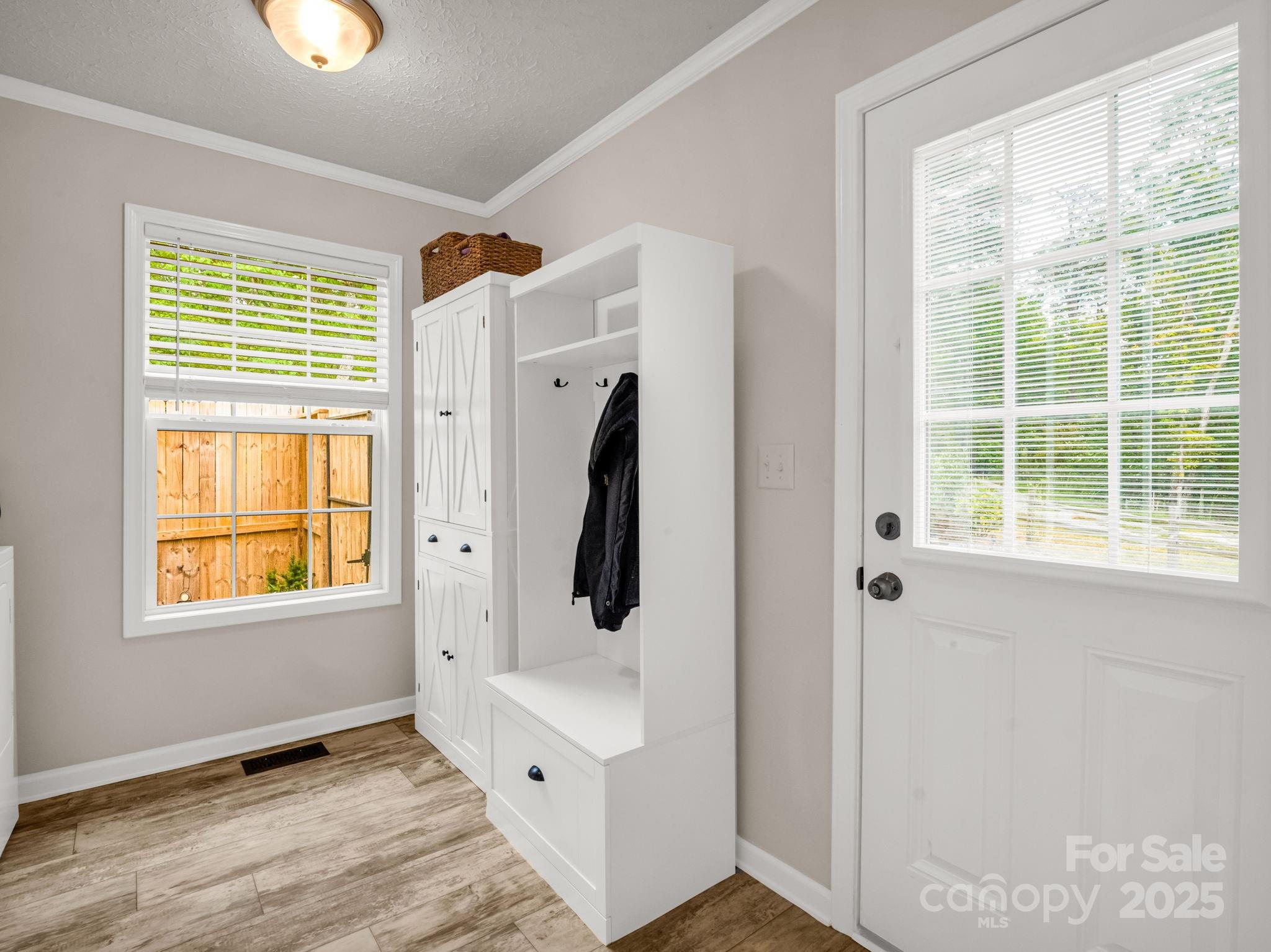 343 East Marshall Ridge Road Hendersonville, NC 28792 - Photo 25 of 44 a view of an empty room with wooden floor and windows