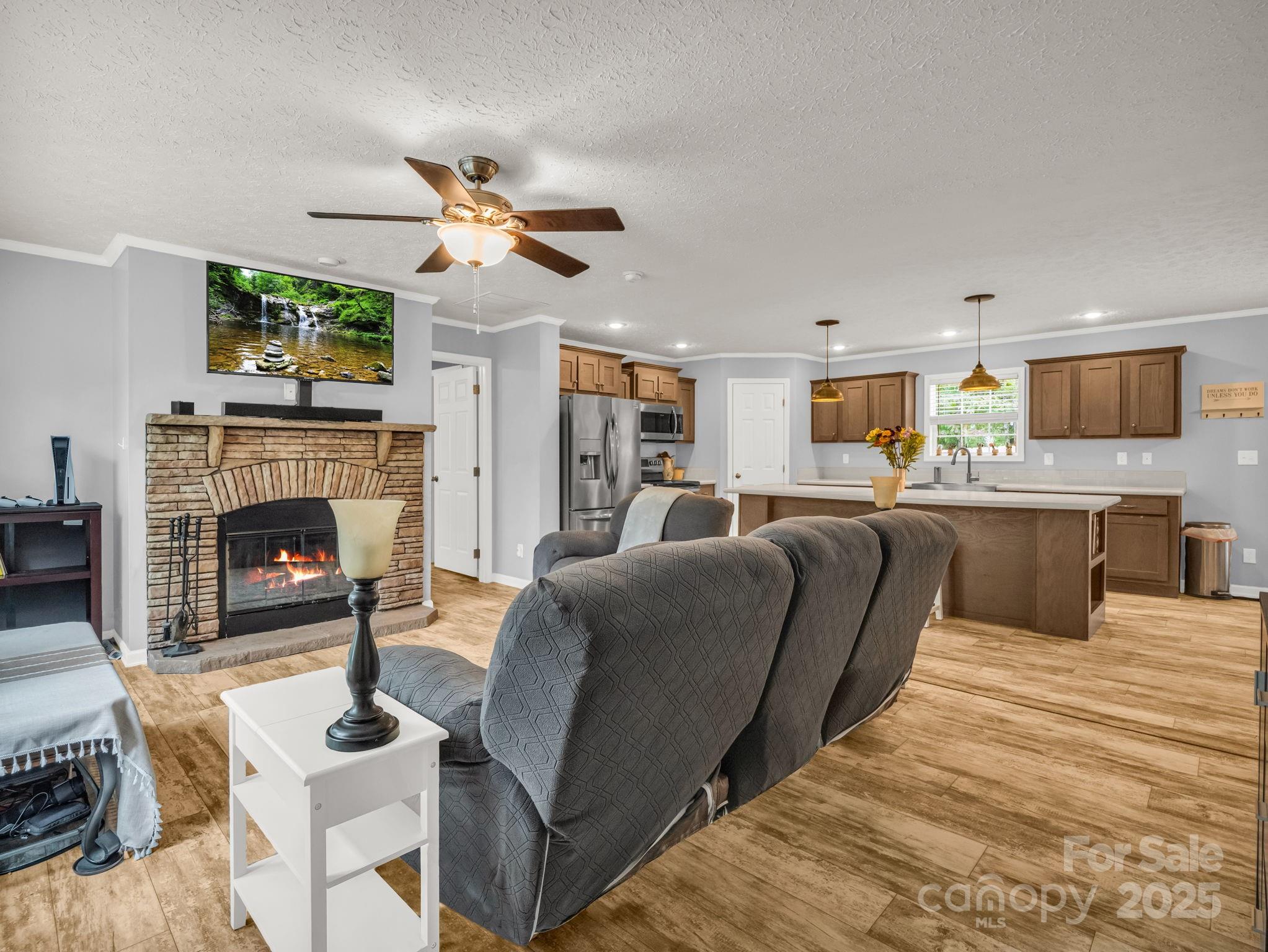 343 East Marshall Ridge Road Hendersonville, NC 28792 - Photo 5 of 44 a living room with furniture a fireplace and a flat screen tv