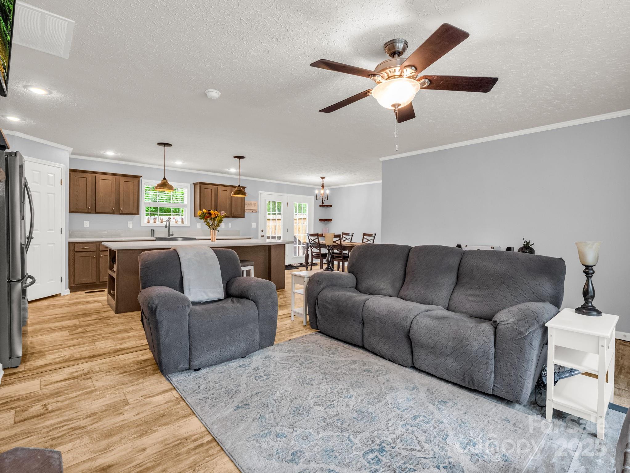 343 East Marshall Ridge Road Hendersonville, NC 28792 - Photo 6 of 44 a living room with furniture kitchen view and a chandelier