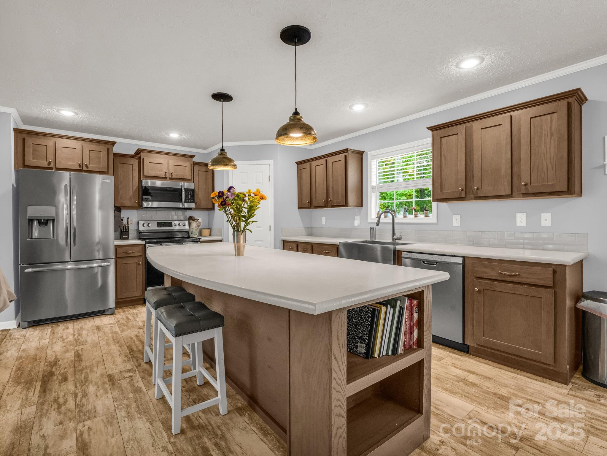 343 East Marshall Ridge Road Hendersonville, NC 28792 - Photo 8 of 44 a kitchen with stainless steel appliances a stove a sink a microwave a refrigerator and cabinets