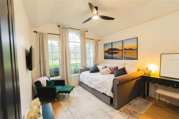 a bedroom with a bed and a chandelier
