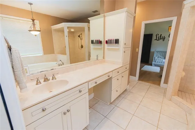 a living room with furniture a fireplace and a large window