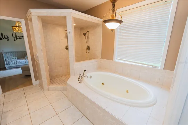 a living room with furniture kitchen view and a wooden floor