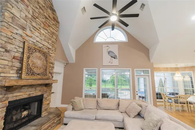 a living room with furniture fireplace and a large window