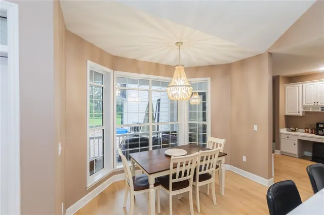 a view of a house with backyard sitting area and a tub