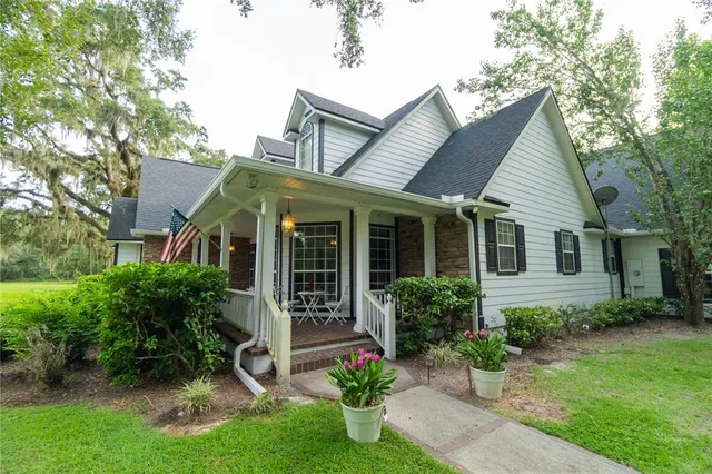 a view of a house with a yard and plants