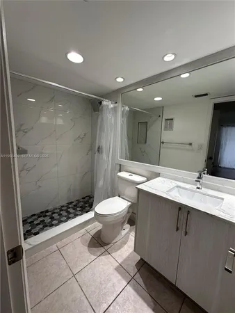 a bathroom with a double vanity sink toilet and shower