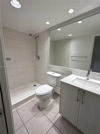 a bathroom with a toilet a sink and shower
