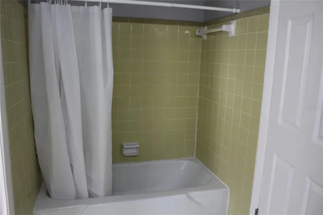 a bathroom with a shower and a bathtub