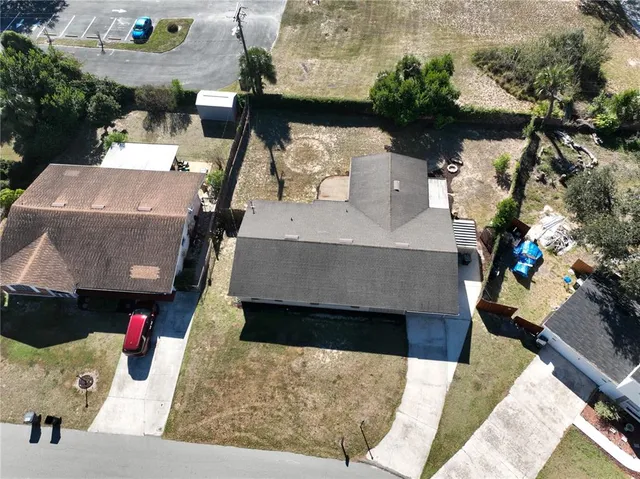 an aerial view of a house with outdoor space