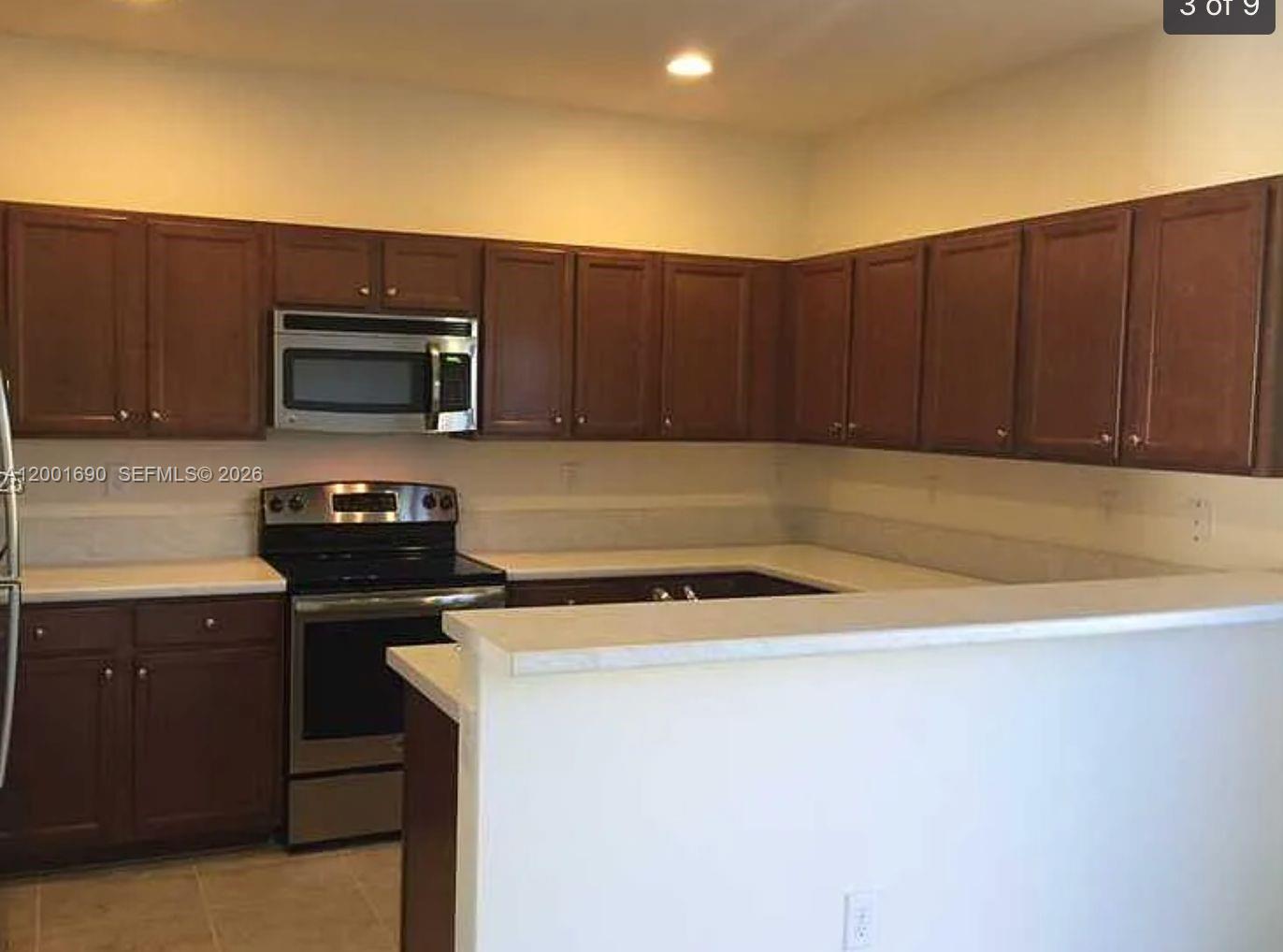 8913 West 35th Way Hialeah, FL 33018 - Photo 3 of 7 a kitchen with a cabinets and steel appliances