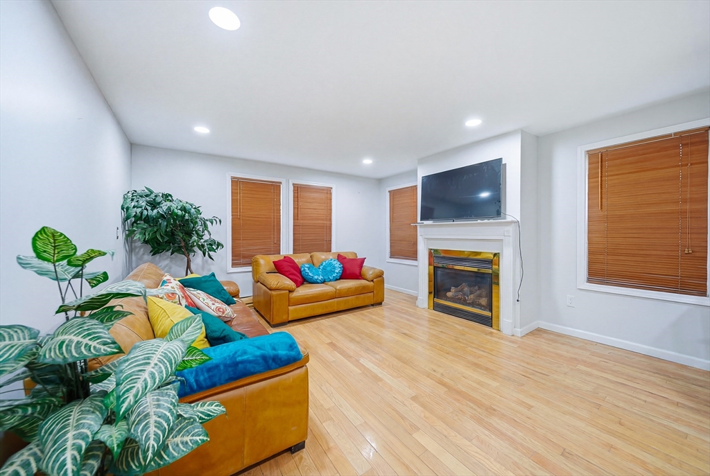 39 Hawthorne Street, Unit 39 Boston, MA 02119 - Photo 5 of 33 a living room with furniture fireplace and flat screen tv