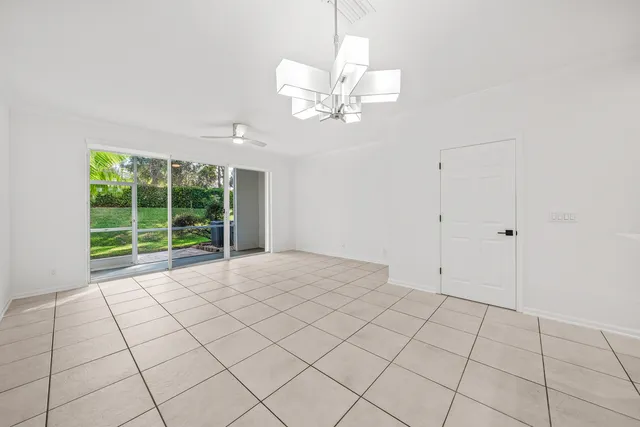 a view of backyard with large trees and plants