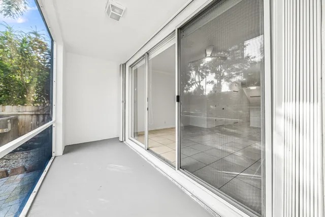 a view of backyard with large trees and plants