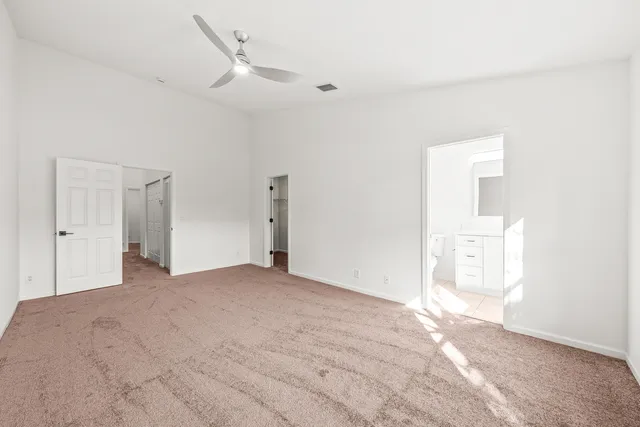 a bathroom with a toilet a sink a vanity and mirror