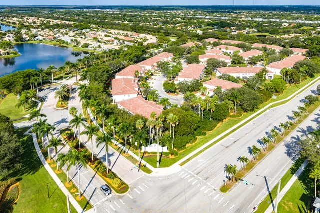 an aerial view of a house with a yard and lake view