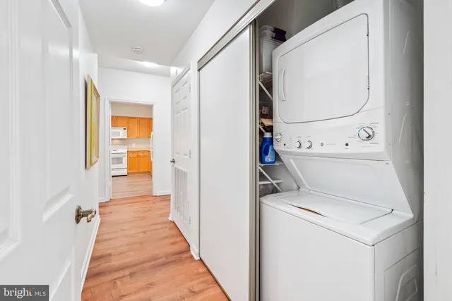 a view of washer and dryer with bathroom in the background