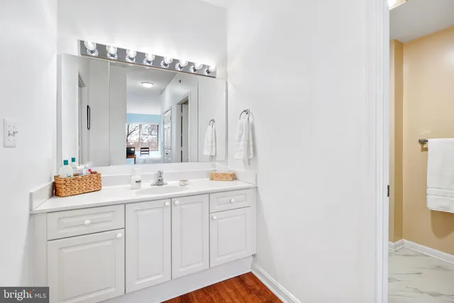 a bathroom with a double vanity sink and mirror with shower