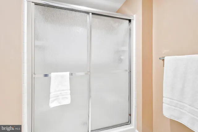 a bathroom with a shower and a glass door