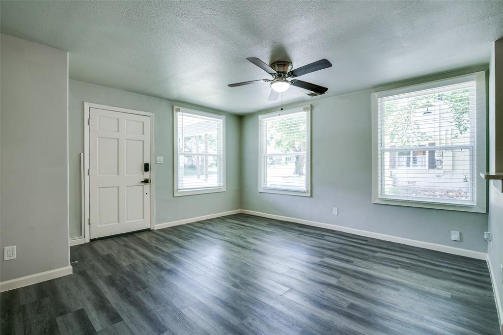 606 West High Street Terrell, TX 75160 - Photo 5 of 28 a view of an empty room with wooden floor and a window