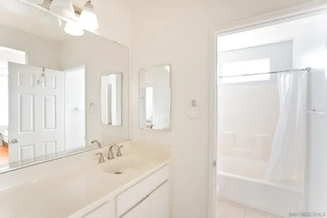 a bathroom with a sink double vanity and a mirror